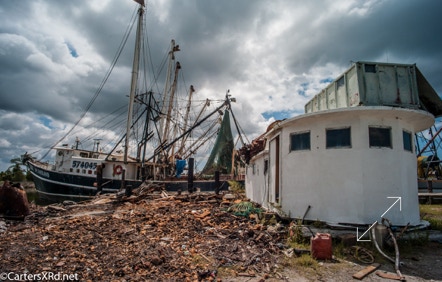 Steel trawler and boat house waiting for another boat.