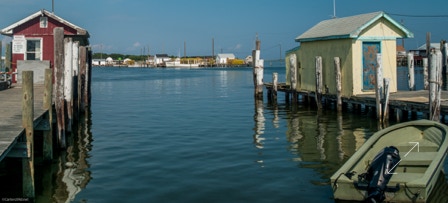 skiff by two fish houses